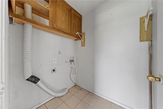 clothes washing area with cabinets, washer hookup, light tile patterned floors, and electric dryer hookup