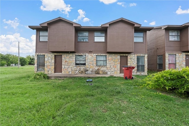 rear view of house with a yard