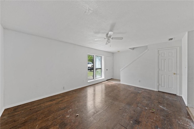 spare room with ceiling fan, a textured ceiling, and hardwood / wood-style flooring