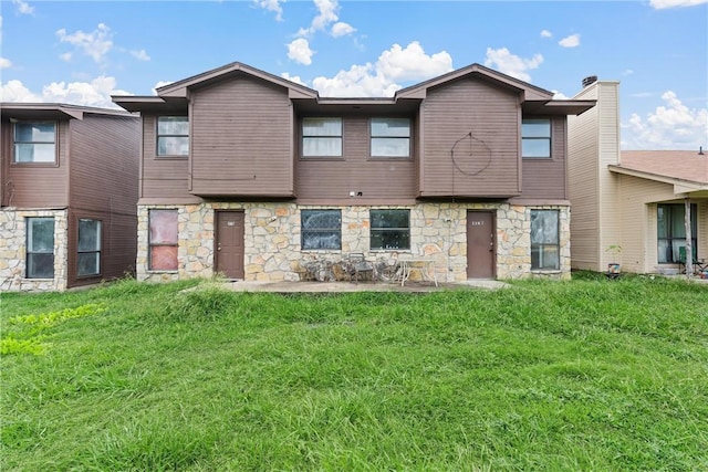 rear view of property featuring a yard