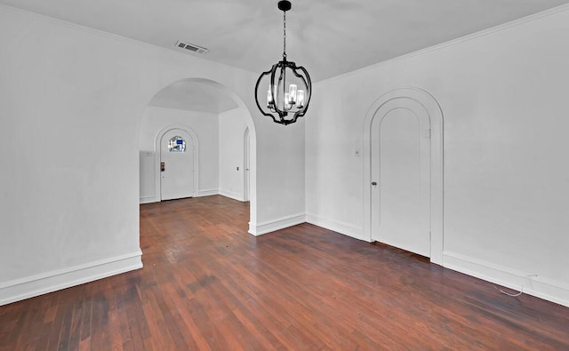 interior space featuring an inviting chandelier, crown molding, and dark wood-type flooring