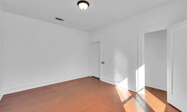 spare room with dark hardwood / wood-style flooring