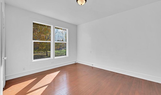 unfurnished room with dark hardwood / wood-style floors