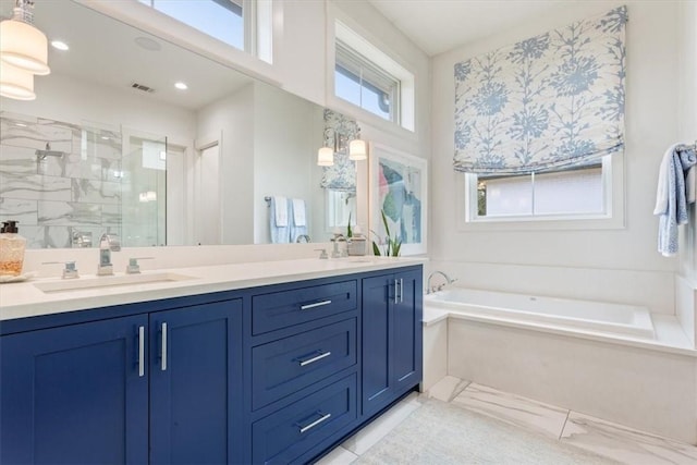 bathroom featuring separate shower and tub and vanity