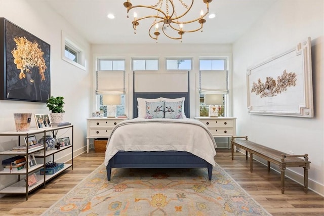 bedroom featuring light hardwood / wood-style floors and an inviting chandelier