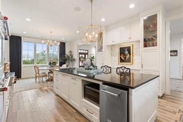 kitchen featuring white cabinets, a chandelier, and a kitchen island