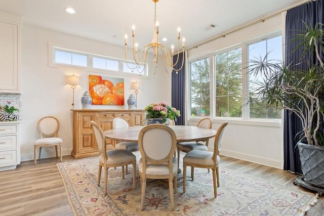 dining room featuring light hardwood / wood-style floors and a chandelier