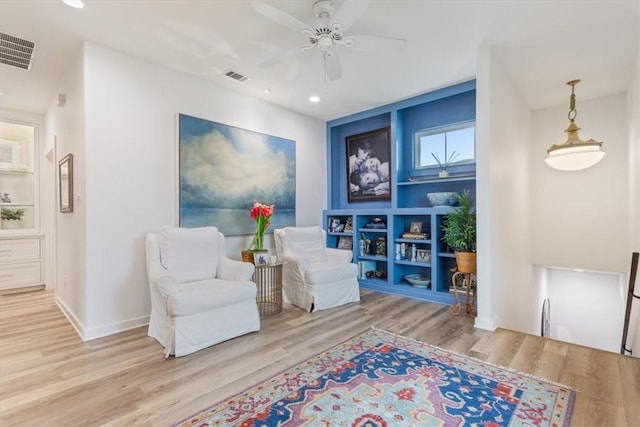 sitting room featuring ceiling fan and light hardwood / wood-style floors