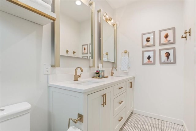 bathroom featuring toilet and vanity