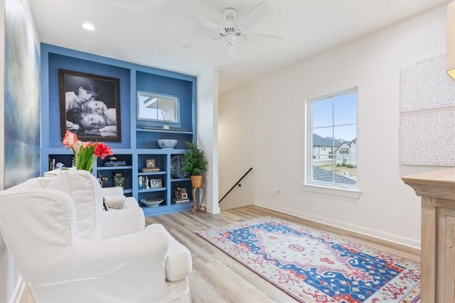 sitting room featuring hardwood / wood-style floors and ceiling fan