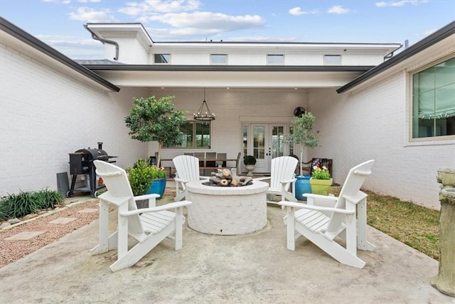 view of patio / terrace featuring french doors and an outdoor fire pit