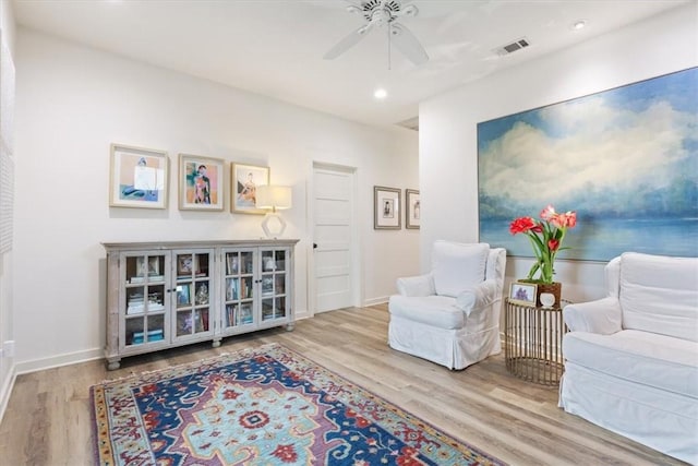 sitting room featuring ceiling fan and light hardwood / wood-style floors