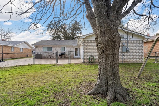 back of property with cooling unit and a yard