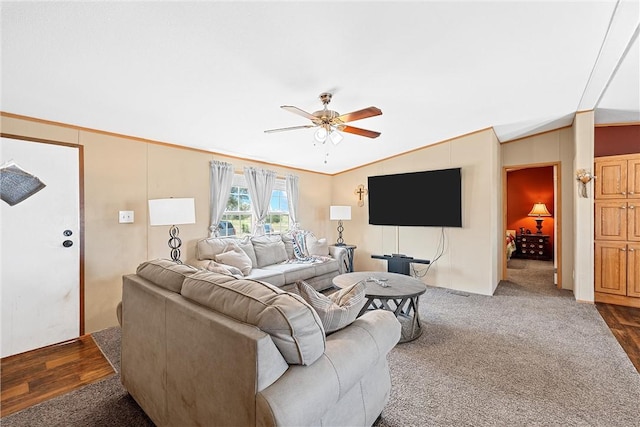 living room with dark hardwood / wood-style flooring, vaulted ceiling, and ceiling fan