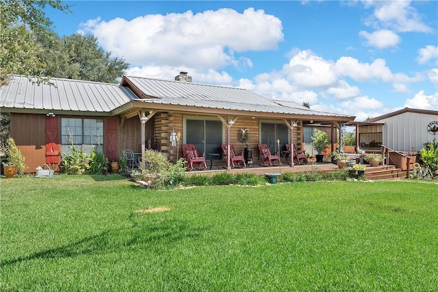 rear view of house with a patio and a lawn