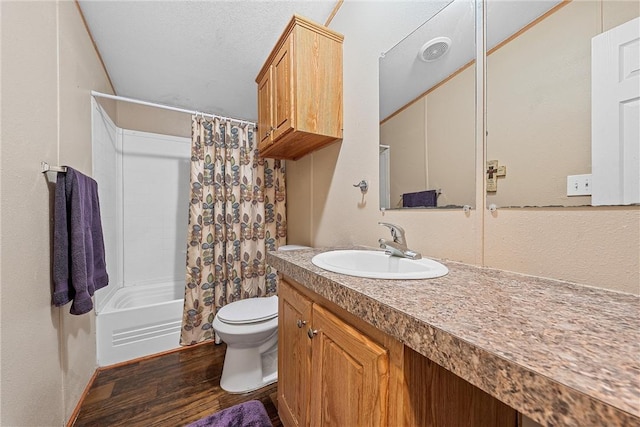 full bathroom with hardwood / wood-style floors, vanity, toilet, and shower / tub combo