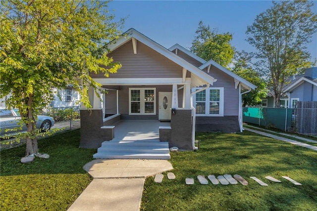 bungalow-style home featuring a porch and a front lawn