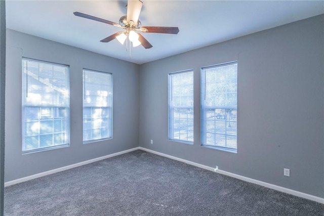 carpeted empty room featuring ceiling fan and a healthy amount of sunlight