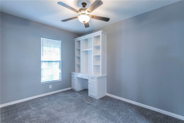 unfurnished bedroom with dark colored carpet and ceiling fan