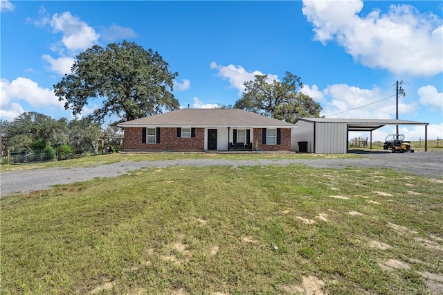 view of front of property featuring a front yard, a carport, and covered porch