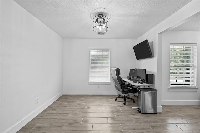 office featuring plenty of natural light and a textured ceiling