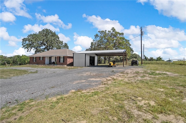 view of front of home with a carport and a front lawn