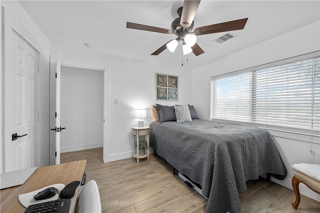 bedroom with ceiling fan and light hardwood / wood-style flooring