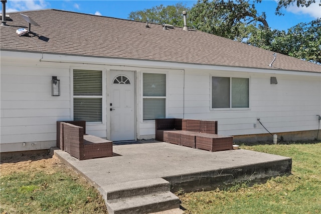 back of property with outdoor lounge area, a patio, and a lawn