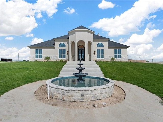 exterior space featuring stone siding, a front lawn, french doors, and stucco siding