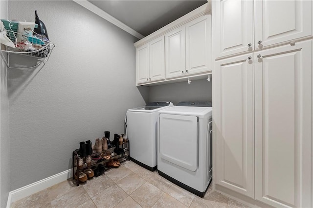 laundry area with cabinets, light tile patterned floors, washer and dryer, and ornamental molding