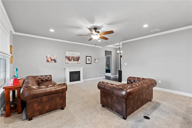 carpeted living room with crown molding and ceiling fan with notable chandelier