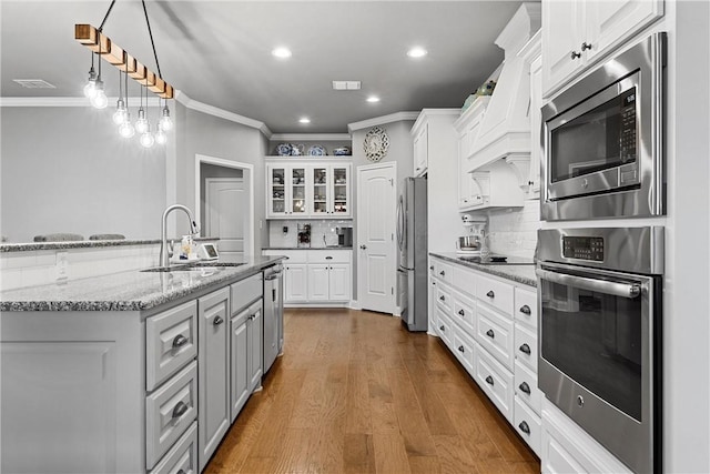 kitchen with white cabinets, dark hardwood / wood-style flooring, sink, and stainless steel appliances