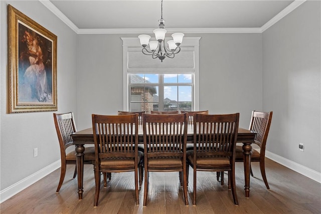 dining area with ornamental molding, wood-type flooring, and a notable chandelier