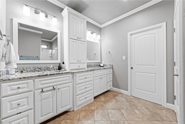 bathroom featuring tile patterned flooring, vanity, and crown molding