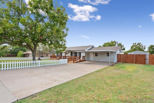 view of front of home featuring a front lawn, a deck, and a carport