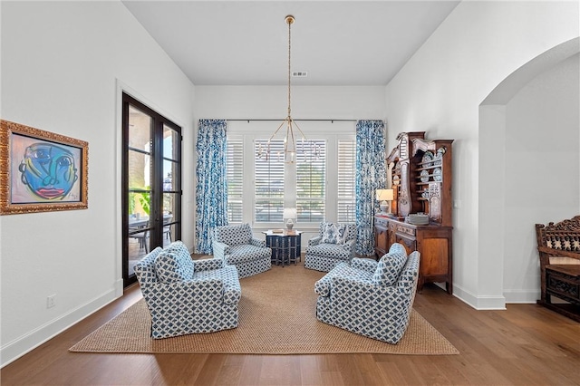 living area with french doors and hardwood / wood-style flooring