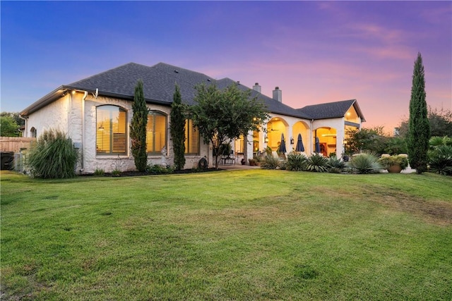 view of front of property with a yard