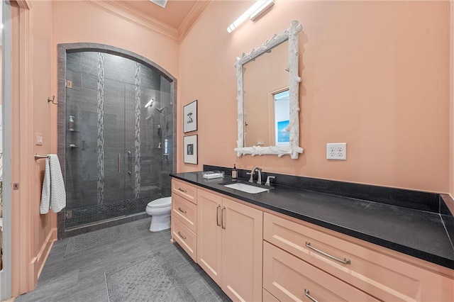 bathroom featuring crown molding, vanity, an enclosed shower, and toilet