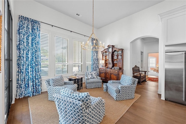 interior space with a chandelier and light hardwood / wood-style floors