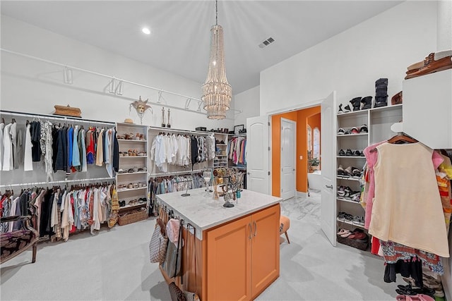 spacious closet featuring light carpet and a chandelier