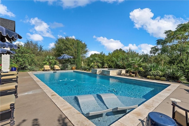 view of swimming pool featuring a patio area and an in ground hot tub