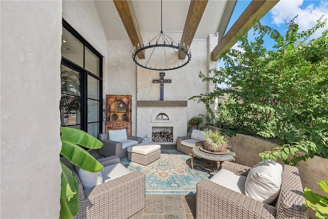 view of patio featuring an outdoor living space with a fireplace