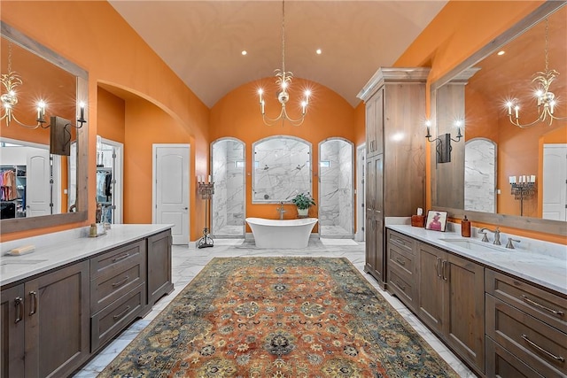 bathroom with vanity, a chandelier, and lofted ceiling