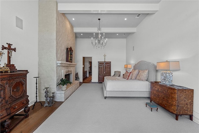 bedroom with beam ceiling, wood-type flooring, a high ceiling, and an inviting chandelier