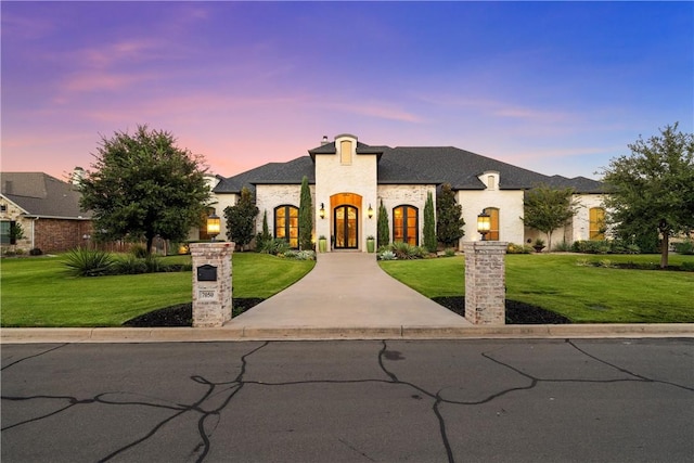 french provincial home with a yard