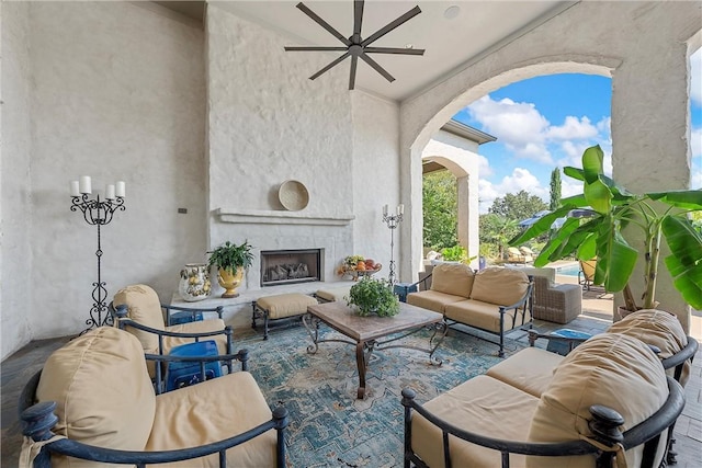 view of patio featuring an outdoor living space with a fireplace and ceiling fan