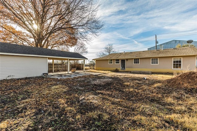 back of property featuring a carport