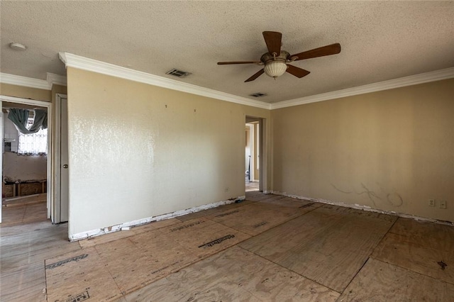 spare room featuring ceiling fan, ornamental molding, and a textured ceiling