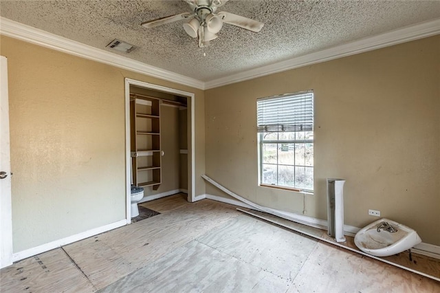 unfurnished bedroom featuring ceiling fan, a textured ceiling, and ornamental molding