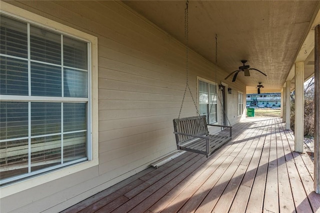 wooden terrace featuring ceiling fan and covered porch